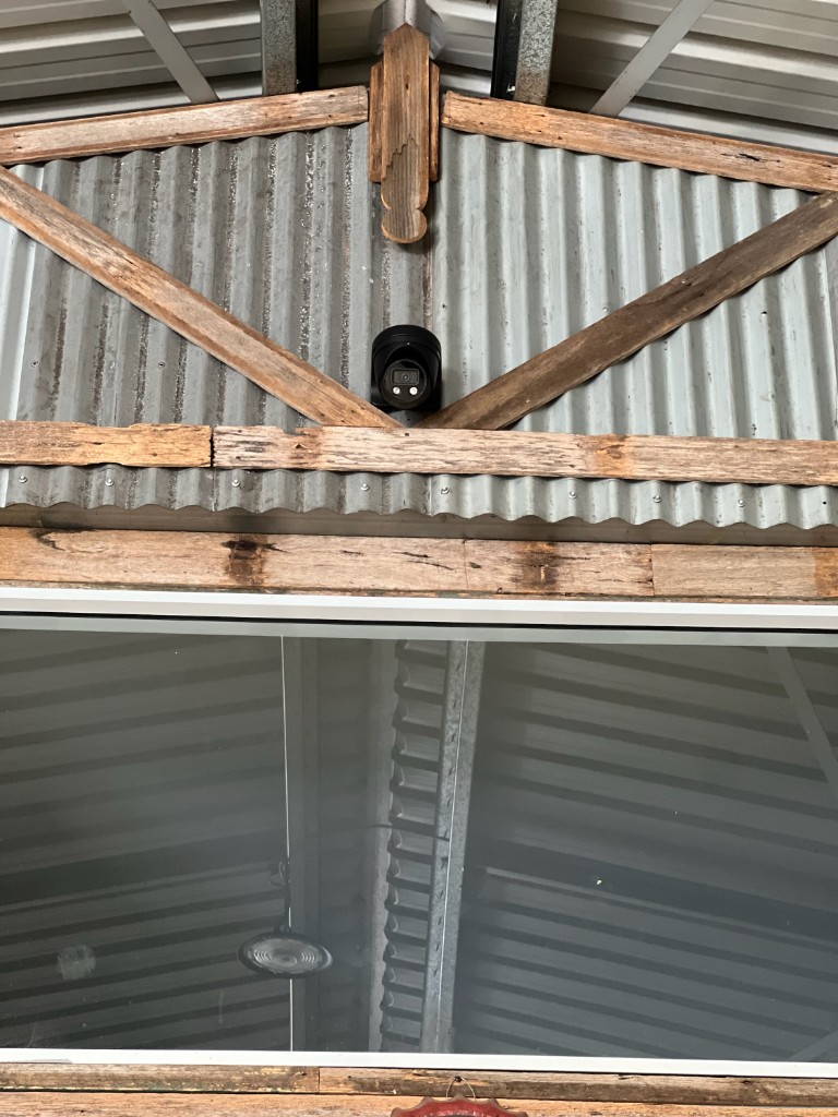 Dome camera mounted to a shed roof truss